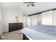 View of the main bedroom featuring a large dresser, vaulted ceiling, and doorway to the en-suite bathroom at 6694 E 129Th Ave, Thornton, CO 80602