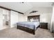 Vaulted ceiling main bedroom with en-suite bathroom, barn-door style door, and mountain-themed decoration at 6694 E 129Th Ave, Thornton, CO 80602