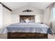 Spacious bedroom with a mountain themed accent wall, large bed with storage, and plenty of natural light at 6694 E 129Th Ave, Thornton, CO 80602