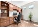 Home office featuring custom built-in cabinets, drawers, and shelving with hardwood floors at 6694 E 129Th Ave, Thornton, CO 80602