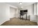 Well-lit home office with neutral carpet, featuring a modern desk setup with dual monitors, perfect for productivity at 6694 E 129Th Ave, Thornton, CO 80602