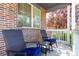 Relaxing porch with seating and a beautiful brick facade for enjoying the outdoors at 6694 E 129Th Ave, Thornton, CO 80602