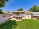 Large backyard featuring a manicured lawn, spacious deck, and storage shed at 1576 S Ursula Ct, Aurora, CO 80012