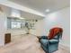 Basement with built-in shelving, window, and comfy chair at 1576 S Ursula Ct, Aurora, CO 80012