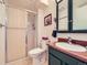 Cozy bathroom with a stand up shower and vanity with dark wood at 1576 S Ursula Ct, Aurora, CO 80012
