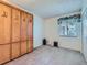 Bedroom with a built-in wood cabinet and a window with patterned valance at 1576 S Ursula Ct, Aurora, CO 80012
