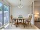 Sunlit dining area with a sliding door, chandelier, and stairway at 1576 S Ursula Ct, Aurora, CO 80012