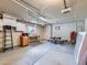 Spacious garage featuring ample lighting, work bench, storage solutions and ladder at 1576 S Ursula Ct, Aurora, CO 80012