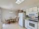 Bright kitchen adjacent to a dining area, featuring modern appliances at 1576 S Ursula Ct, Aurora, CO 80012