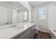 Modern bathroom with gray vanity and a soaking tub at 1386 Bloom St, Brighton, CO 80601