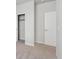 Bedroom with gray carpet, closet and door to hallway at 1386 Bloom St, Brighton, CO 80601