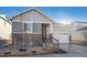 New construction home with gray siding, stone accents, and a two-car garage at 1386 Bloom St, Brighton, CO 80601