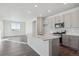 Open concept kitchen with island, gray cabinets, and stainless steel appliances at 1386 Bloom St, Brighton, CO 80601