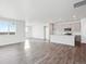 Open concept kitchen and living area with modern cabinetry and hardwood floors at 1386 Bloom St, Brighton, CO 80601