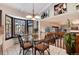 Bright breakfast nook with glass table and views from a large window at 4696 S Yates St, Denver, CO 80236