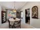 Elegant dining room with a chandelier and large window overlooking backyard at 4696 S Yates St, Denver, CO 80236