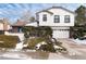 Two-story home with a white exterior and attached garage at 4696 S Yates St, Denver, CO 80236