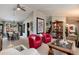 Open living room with red armchairs, and view into dining area at 4696 S Yates St, Denver, CO 80236