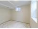 Bright basement bedroom showcasing marble-style flooring and natural light from two windows at 6735 W 2Nd Ave, Lakewood, CO 80226