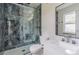 Elegant bathroom with vanity, tub, toilet, and glass enclosed shower with decorative tile surround at 6735 W 2Nd Ave, Lakewood, CO 80226