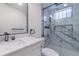 Updated bathroom features a marble-tiled shower, glass door, and modern vanity at 6735 W 2Nd Ave, Lakewood, CO 80226