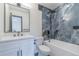 Bathroom with double vanity, elegant tile, bathtub, and walk-in shower at 6735 W 2Nd Ave, Lakewood, CO 80226