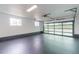 Spacious garage with modern glass door, offering ample parking and natural light at 6735 W 2Nd Ave, Lakewood, CO 80226