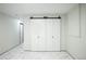 Hallway with sliding closet doors and marble-style flooring, providing modern storage solutions at 6735 W 2Nd Ave, Lakewood, CO 80226