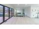 Spacious living room with modern glass doors, a fireplace, and an open layout leading to the kitchen at 6735 W 2Nd Ave, Lakewood, CO 80226