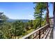 Beautiful mountain and forest views from this home's spacious balcony, with natural wood railing at 22598 Westview Ave, Golden, CO 80401