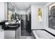 Modern bathroom with a soaking tub, walk-in shower, and unique black tiled shower at 22598 Westview Ave, Golden, CO 80401