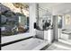 Elegant bathroom featuring a soaking tub with a view and a double vanity with mirrored cabinets at 22598 Westview Ave, Golden, CO 80401