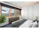 Serene bedroom featuring custom closets, stylish gray bedding, and a large window with a view at 22598 Westview Ave, Golden, CO 80401