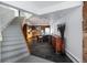 Spacious entryway leading to an open-concept kitchen, featuring sleek flooring and staircase at 22598 Westview Ave, Golden, CO 80401