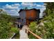 Exterior view of a mountain home with wood and painted siding, stone walkway, and a small deck at 22598 Westview Ave, Golden, CO 80401