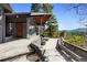 Inviting patio featuring flagstone flooring, stone benches, and a cozy outdoor fireplace with beautiful views at 22598 Westview Ave, Golden, CO 80401