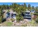 Mountain home nestled on a rocky cliffside with mature trees providing privacy at 22598 Westview Ave, Golden, CO 80401
