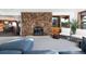 Comfortable living room featuring stone fireplace, plush seating, and scenic views at 22598 Westview Ave, Golden, CO 80401