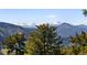 Stunning mountain view featuring snow-capped peaks beyond a lush forest at 22598 Westview Ave, Golden, CO 80401
