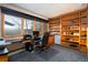 Bright office space with large windows offering scenic views and custom built-in bookshelves at 22598 Westview Ave, Golden, CO 80401