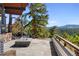 Charming outdoor patio with stone flooring, fire pit, and built-in seating at 22598 Westview Ave, Golden, CO 80401