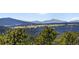 Scenic view of lush green forest, rolling hills, and snow-capped mountains in the distance at 22598 Westview Ave, Golden, CO 80401