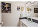 Bathroom featuring a white vanity, stone backsplash, and sports themed decor at 3141 S Tamarac Dr # 110G, Denver, CO 80231