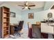 Bright kitchen and desk nook with wood-look tile flooring and a ceiling fan at 3141 S Tamarac Dr # 110G, Denver, CO 80231