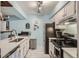 Kitchen featuring white cabinetry, stainless steel appliances, and stone countertops at 3141 S Tamarac Dr # 110G, Denver, CO 80231