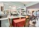 Bright kitchen with white cabinets, stainless steel appliances, and breakfast bar seating at 3141 S Tamarac Dr # 110G, Denver, CO 80231