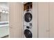 Laundry closet featuring a stacked washer and dryer unit at 3141 S Tamarac Dr # 110G, Denver, CO 80231