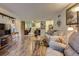 Open-concept living area with hardwood floors and plenty of natural light at 3141 S Tamarac Dr # 110G, Denver, CO 80231