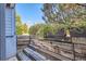 The patio features a charming, rustic wood retaining wall with thriving plants and views of the surrounding greenery at 3141 S Tamarac Dr # 110G, Denver, CO 80231