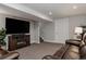 Finished basement with a cozy seating area, fireplace, and entertainment center at 8559 W 75Th Pl, Arvada, CO 80005